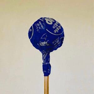 A blue lollipop with white text on a stick.