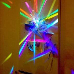 Colorful abstract light sculpture on wall.