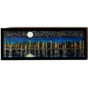 City skyline at night with moon.