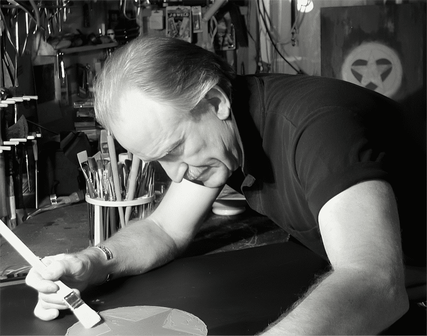 Man painting in an art studio, focused.