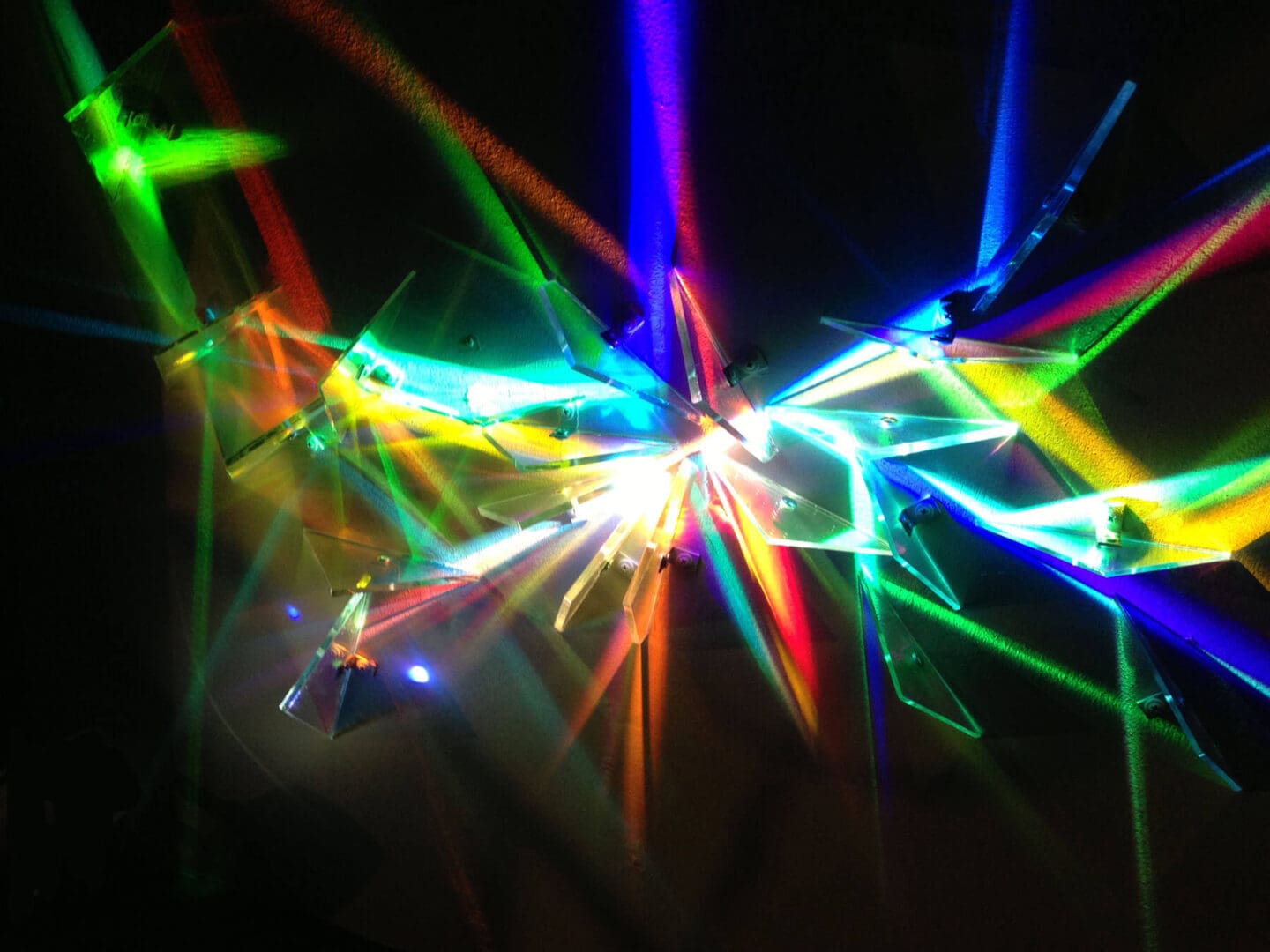 Abstract colorful light beams radiating in different directions.
