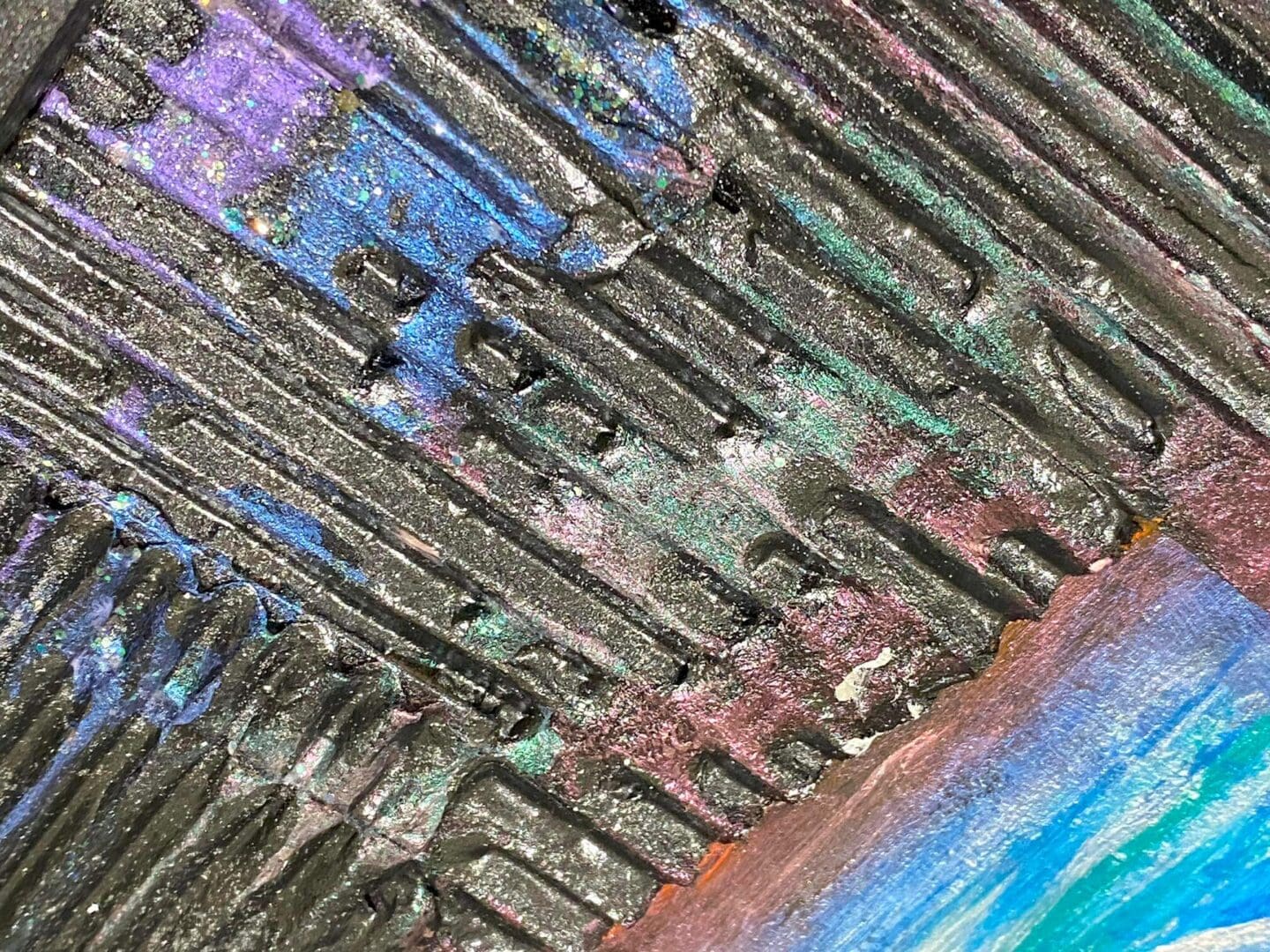 Close-up of colorful, textured abstract art with layered patterns.