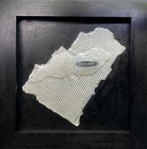 Abstract artwork with textured torn fabric on a black background.