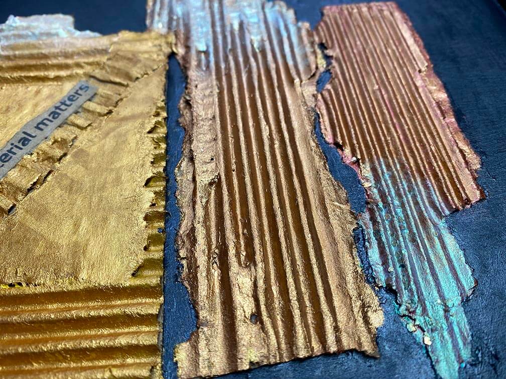 Three pieces of corrugated metal sheets with different rust and paint.