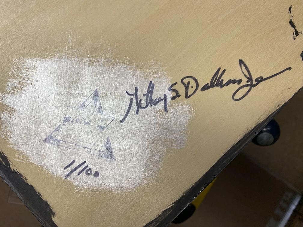 Close-up of a signed and numbered artwork or collectible item.