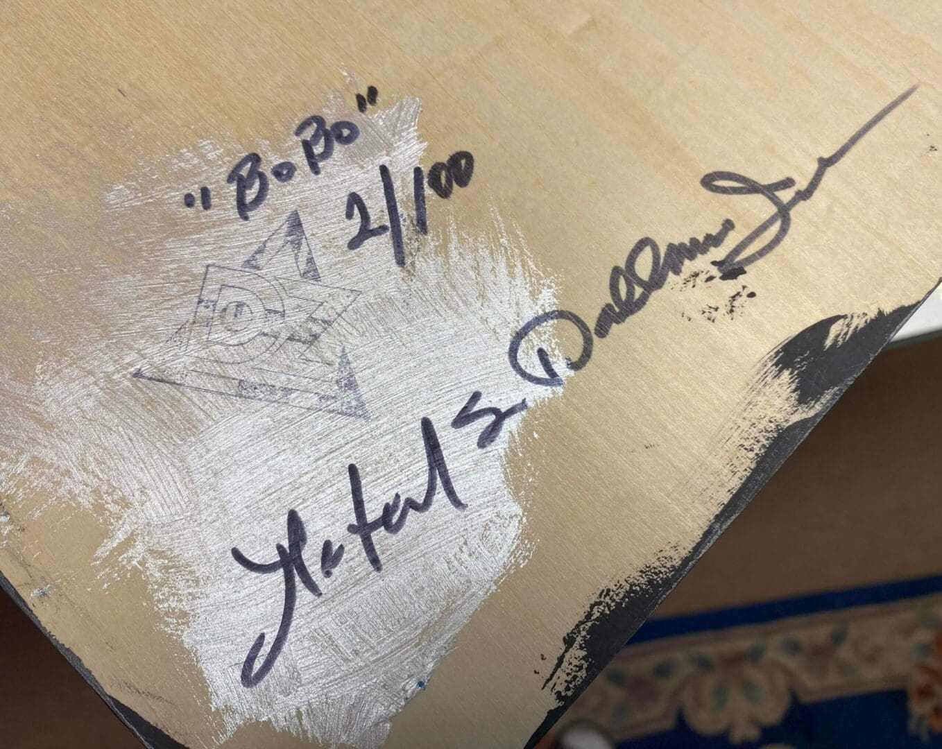 Close-up of a signed item with inscriptions, including "Bo Bo" and a limited edition number 21/100.