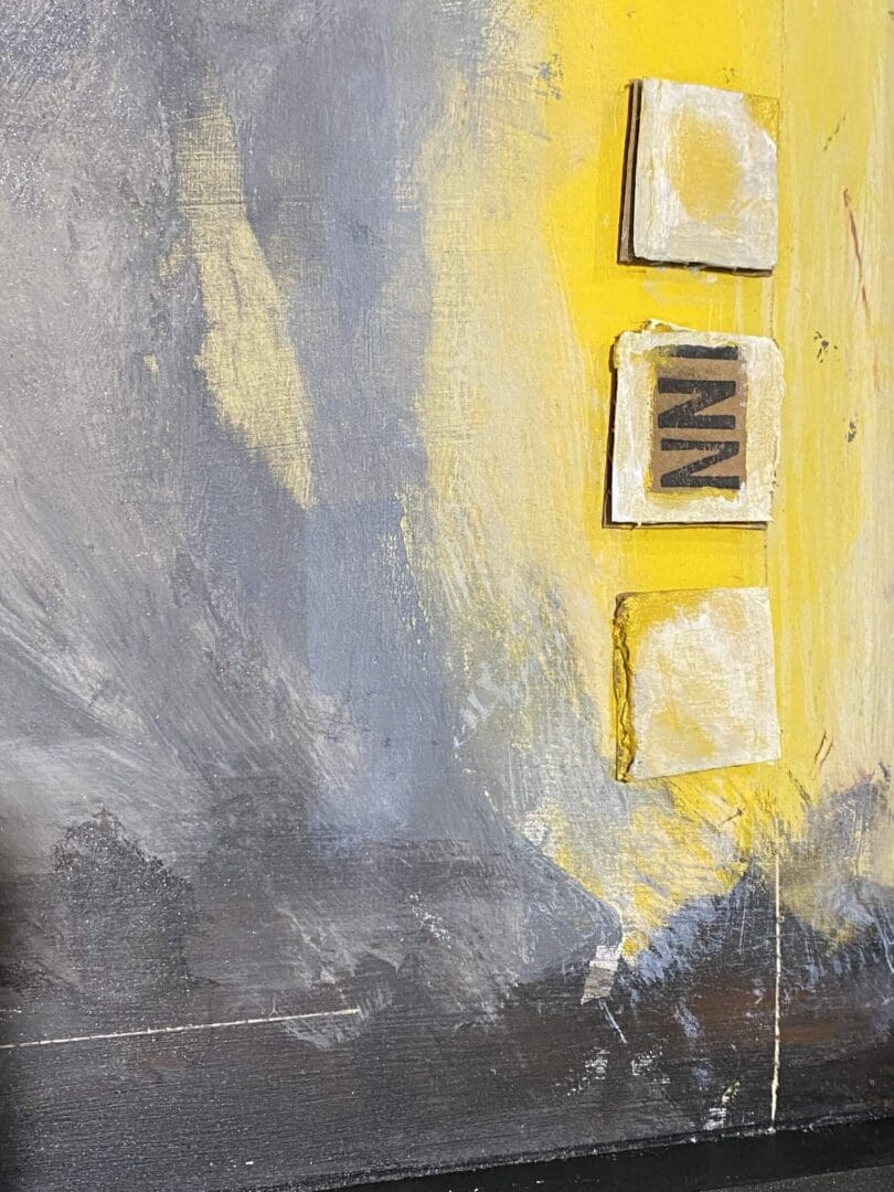 Abstract painting with yellow, gray, and white colors and three blocks with letters.