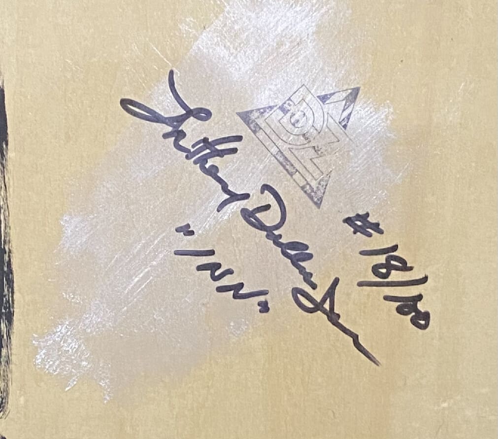 A close-up of a signature with edition number and date.