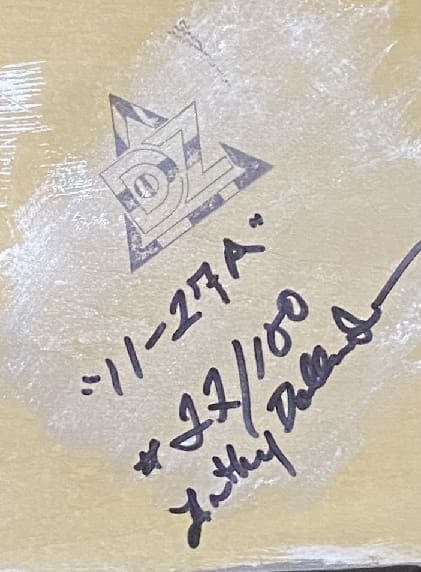 Close-up of a signed and numbered artwork corner.