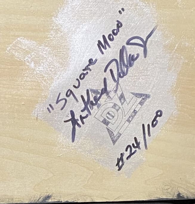 A signed and numbered wooden item by an artist named X. Michael Dillon.