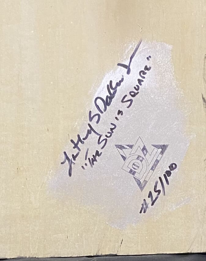 Handwritten note with a name, date, and edition number on a beige surface.