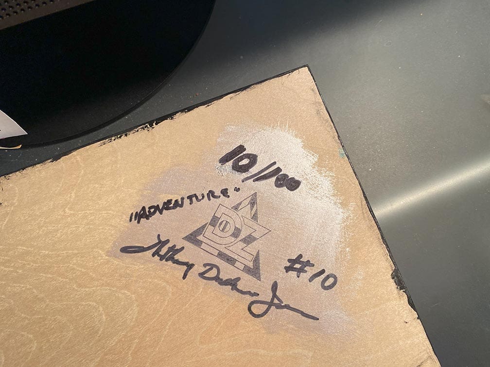 A signed autograph on a piece of cardboard with a time noted.