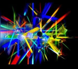 Vibrant multicolored light beams intersect against a dark background.