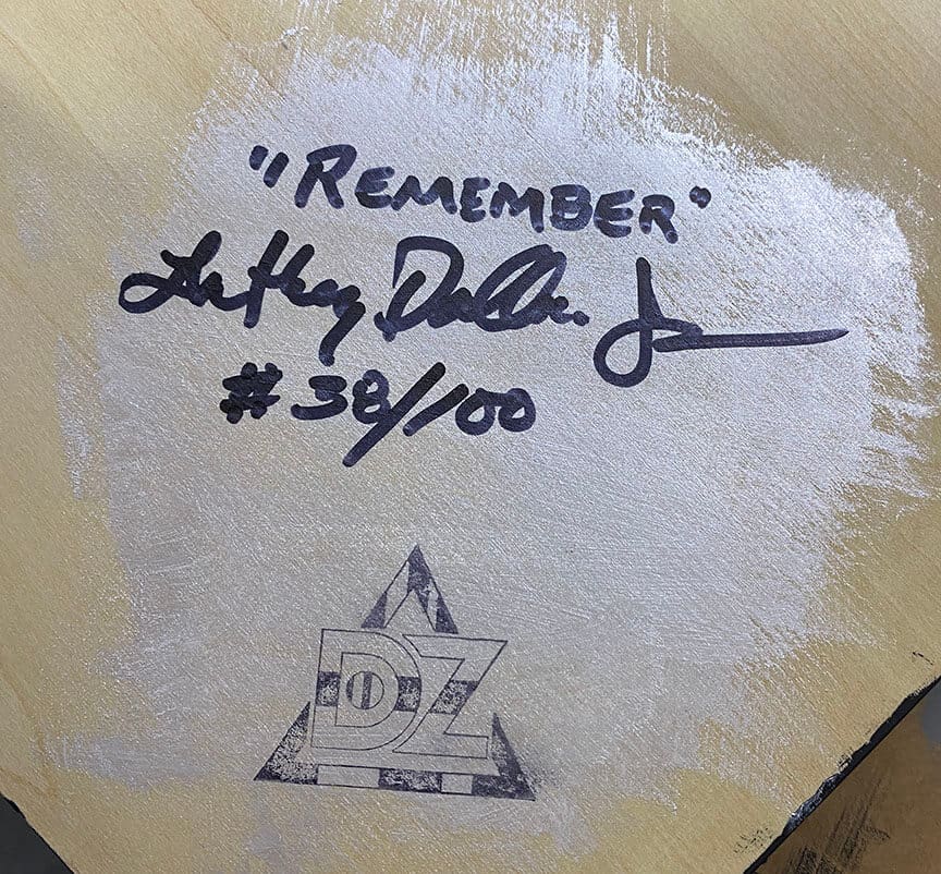 Autographed art piece with signature and number.